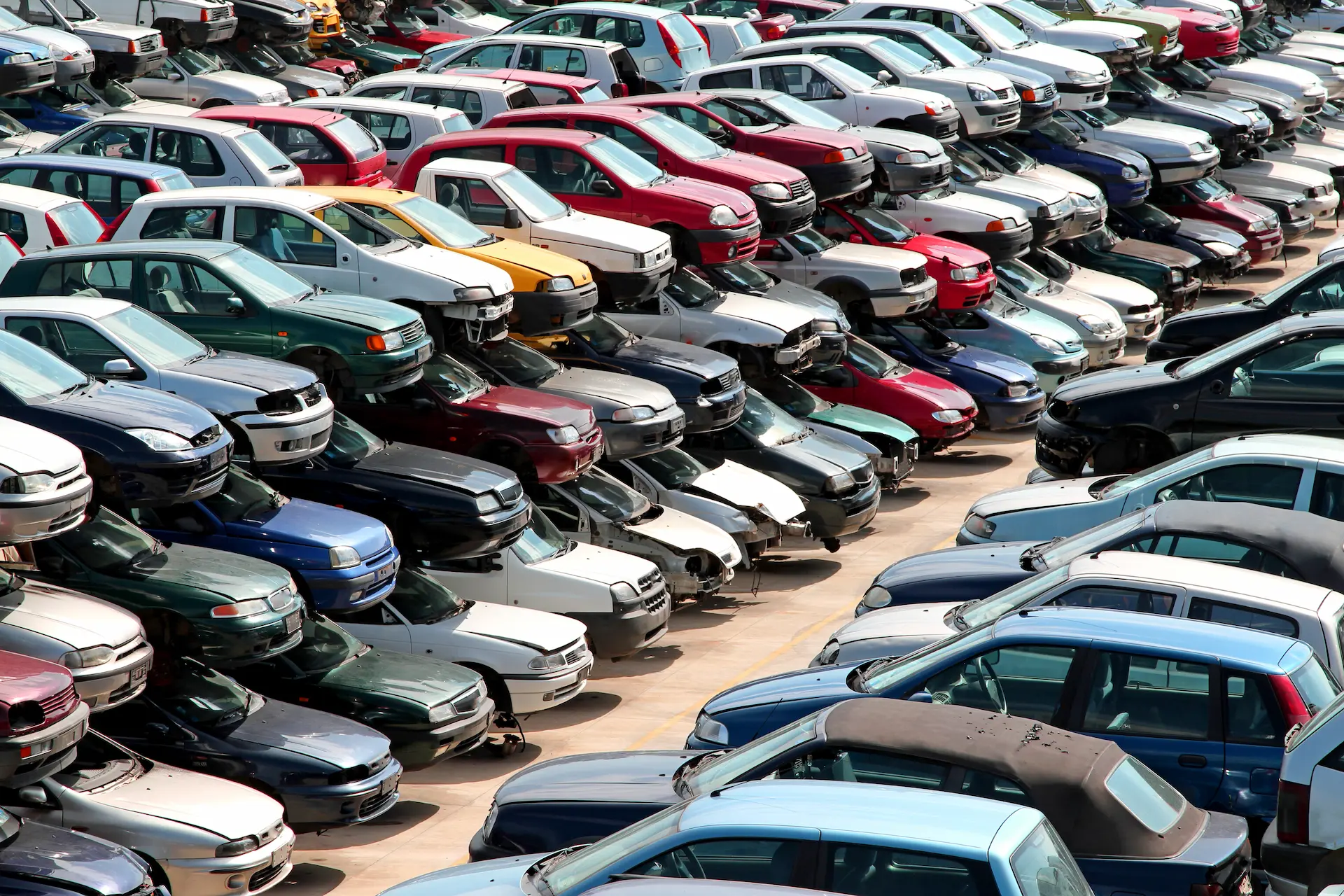 stacks of cars on a scrap yard
